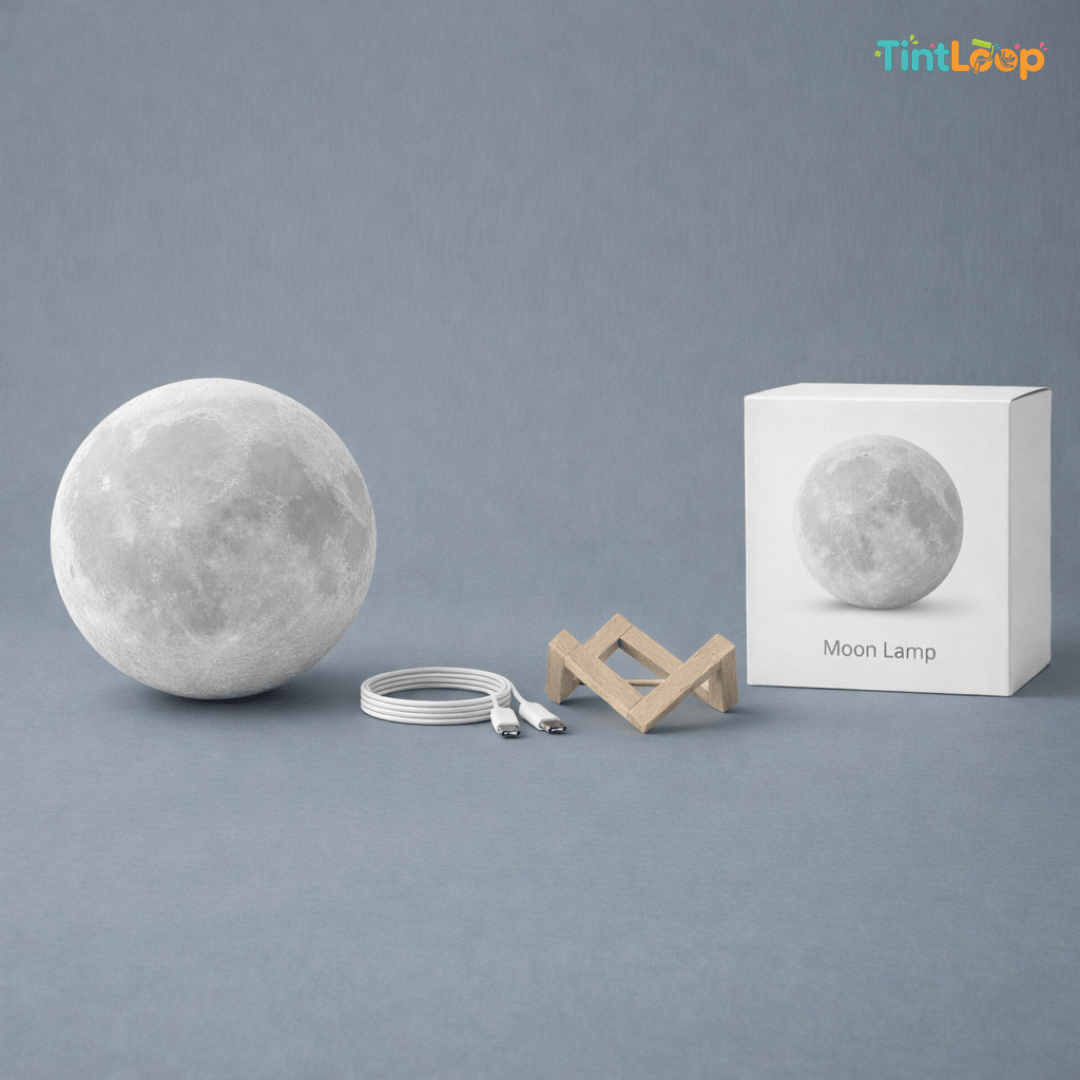 Moon-shaped lamp with packaging and stand on a gray background, featuring the brand 'TintLoop'.