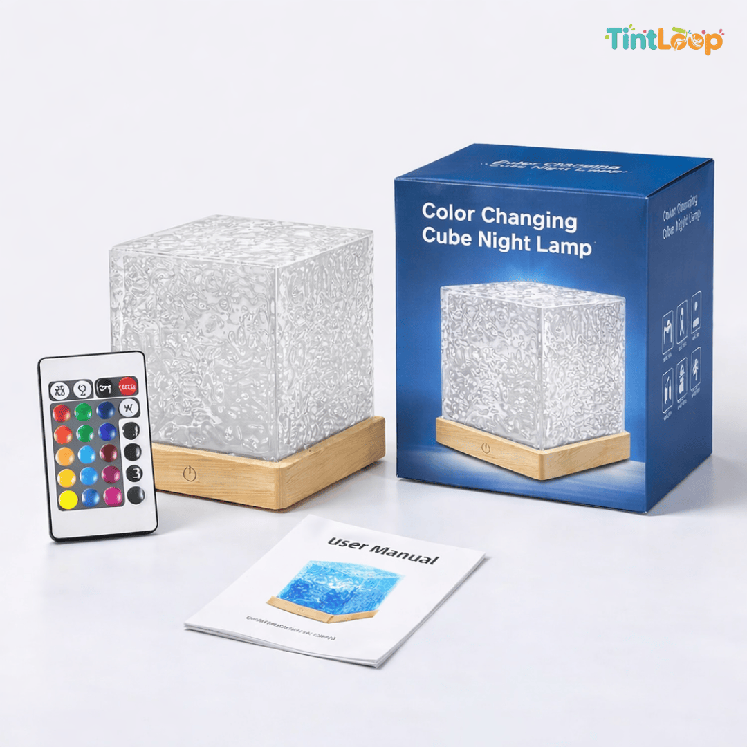 Color-changing cube night lamp with remote control and user manual on a white background